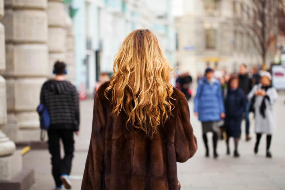 Woman with blonde wavy hair from behind