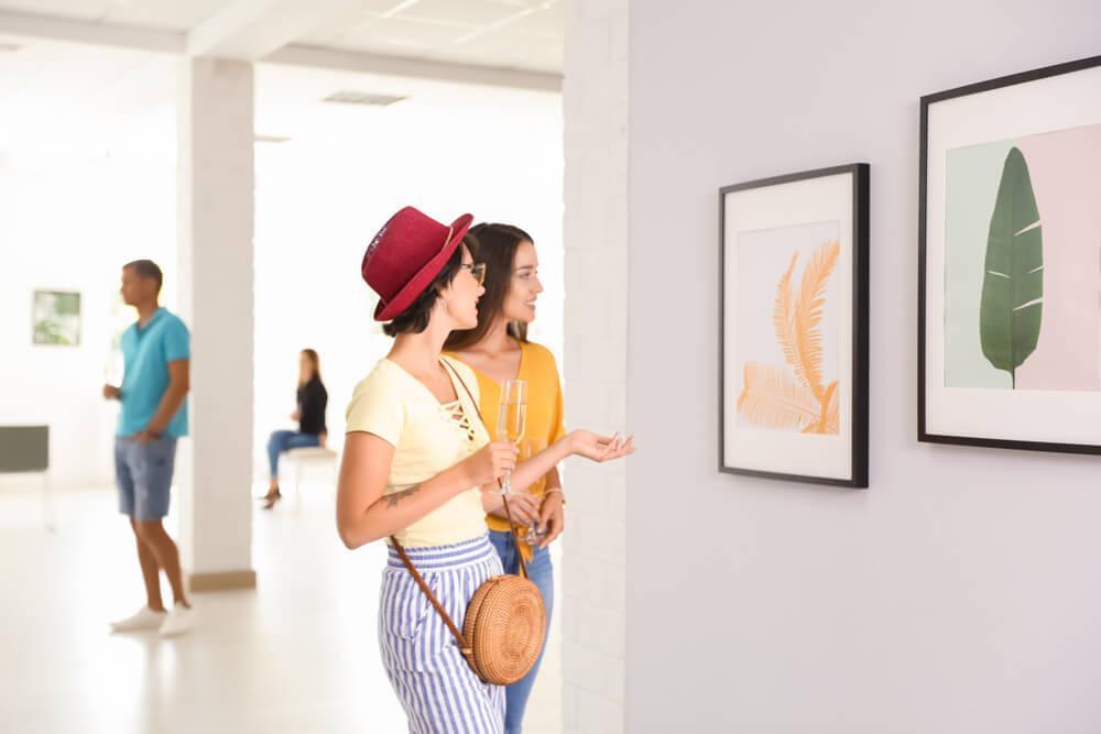 Women looking at art on gallery wall