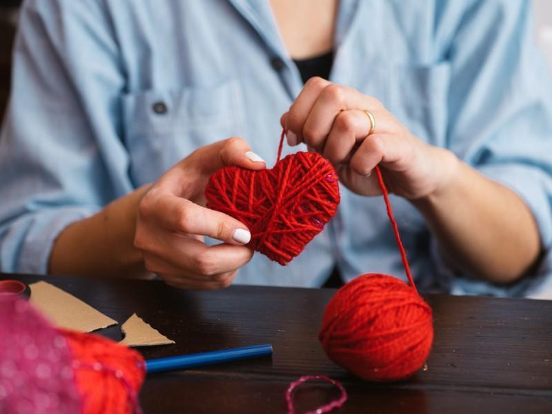 woman knitting a heart