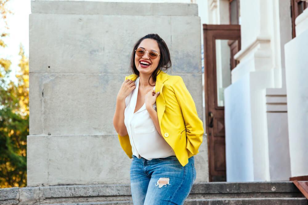 Happy woman with yellow blazer and sunglasses