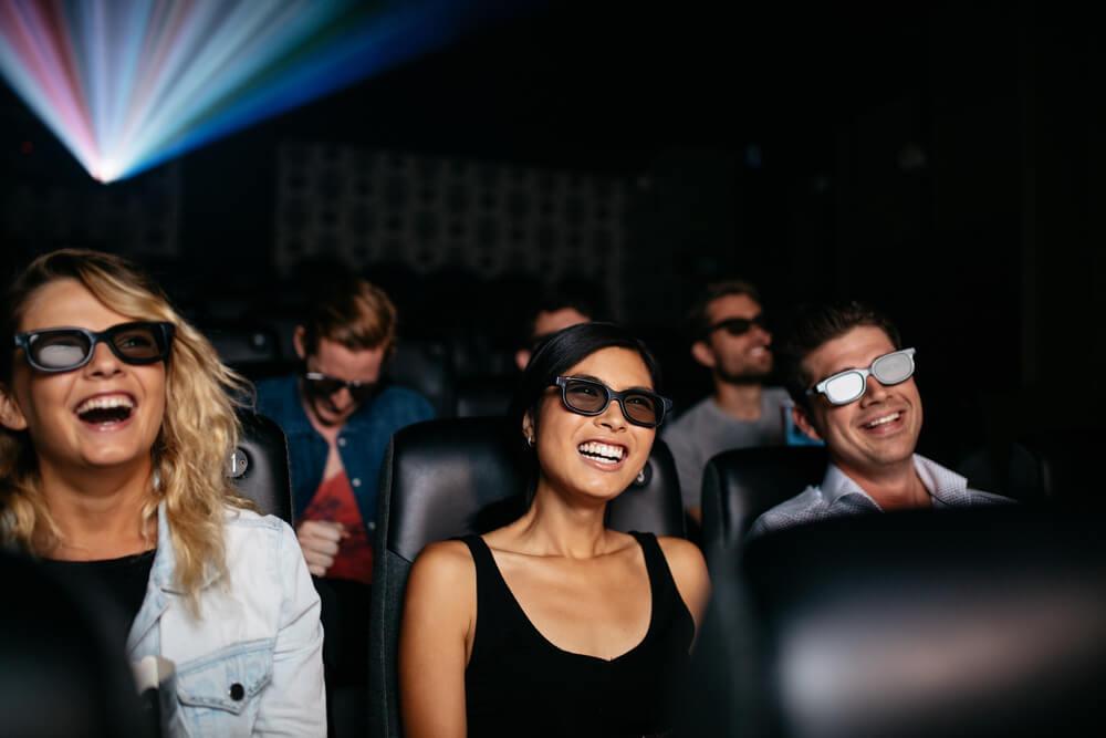 Happy people in a cinema watching an unknown film