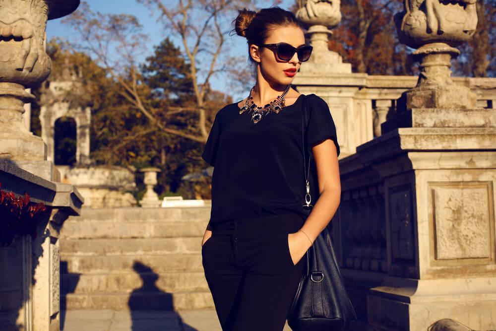 Fashionable woman with sunglasses at sunset