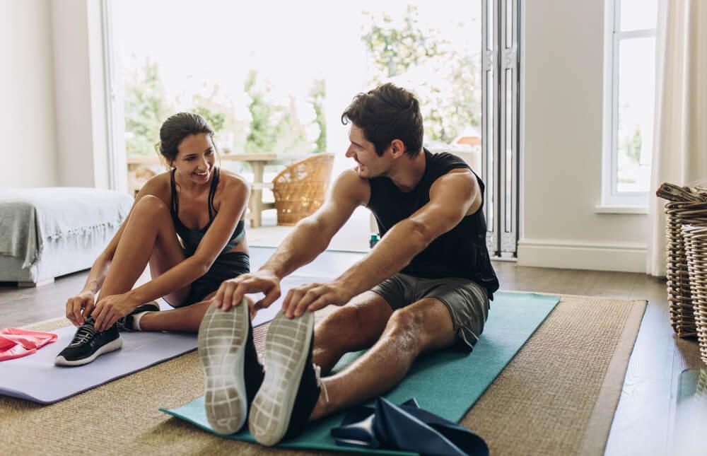 Woman and man exercising at home