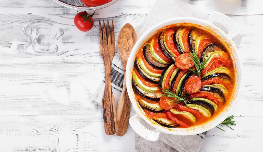 Dish on table with wooden fork and spoon