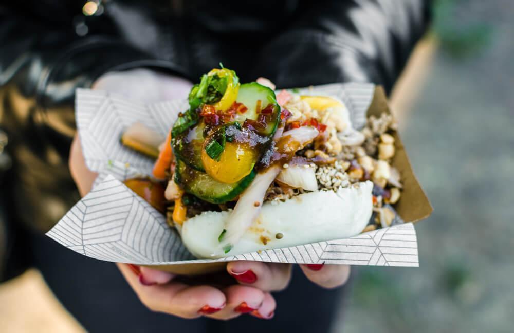 Woman holding street food dish