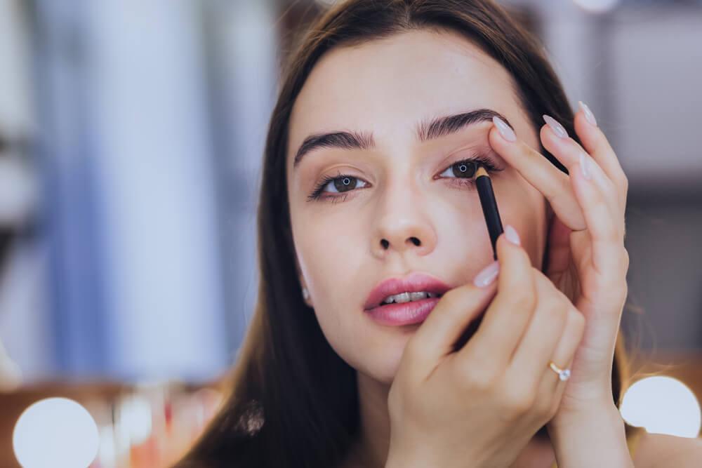 Woman applying eyeliner