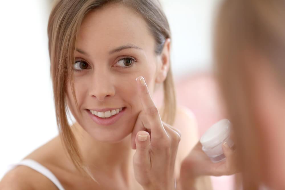 Woman applying face cream