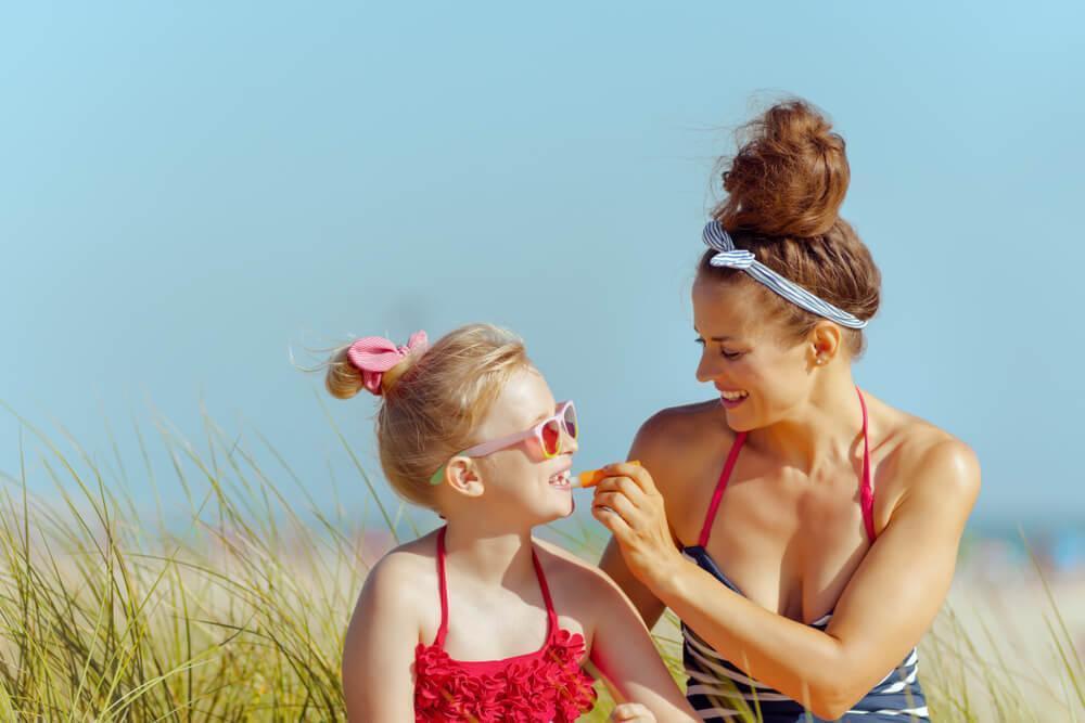 Mother applying SPF to child