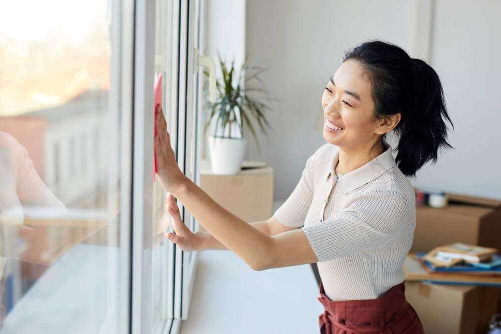 Woman cleaning window