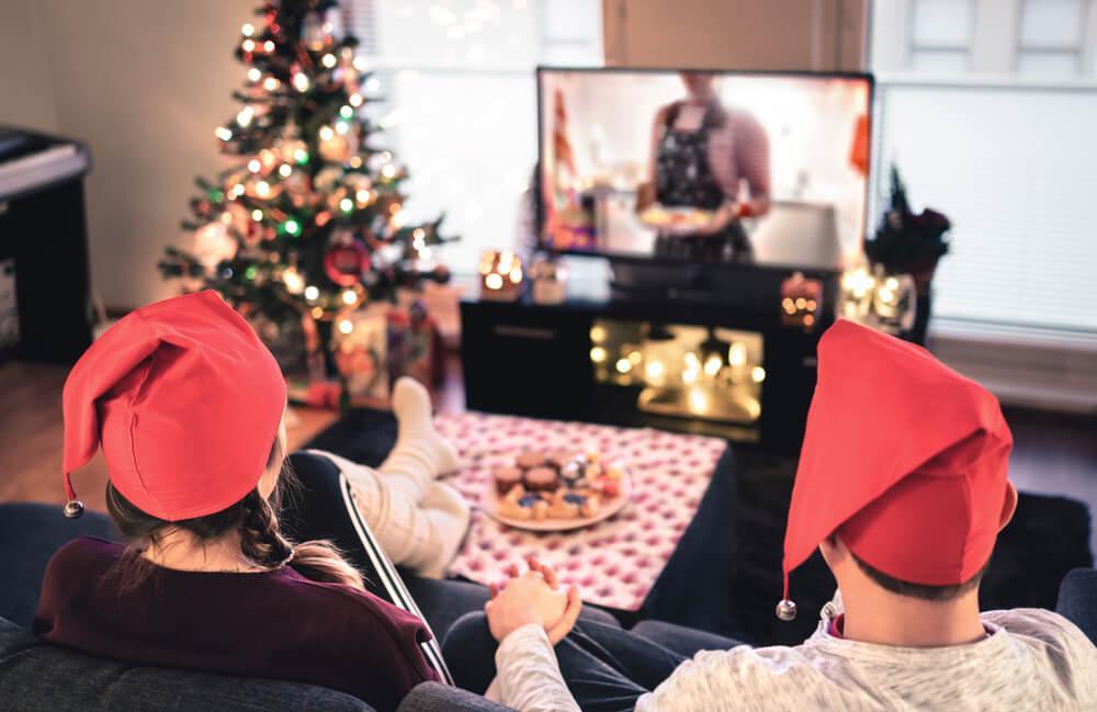 Couple watching TV at Christmas
