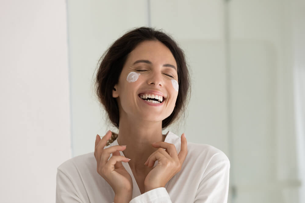 Woman using expired face cream