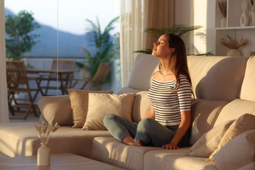 Woman practicing Voo breathing somatic exercises