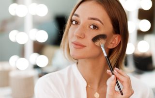 Woman applying blush in a way that ensures it doesn't disappear
