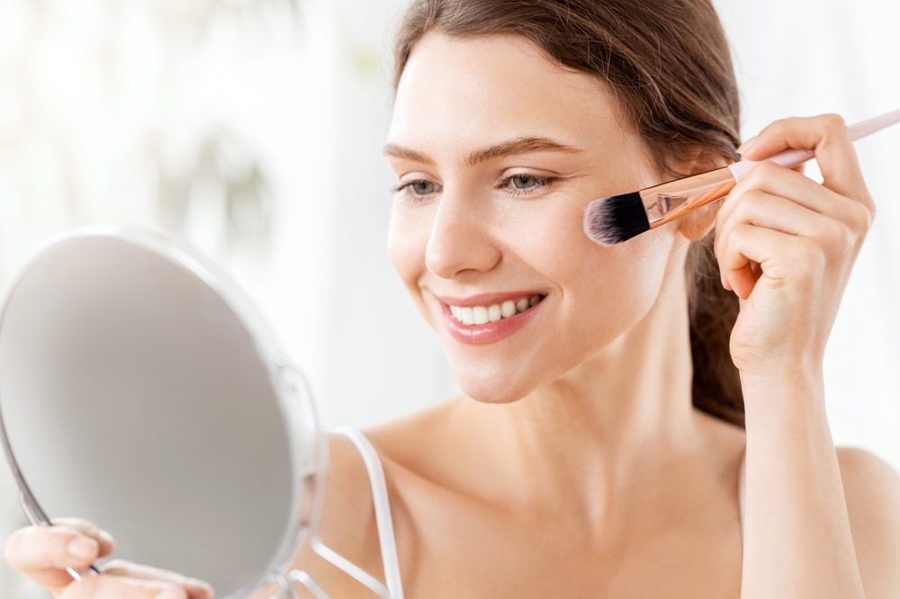 Woman applying blush